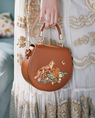 Fox & Pumpkin Embroidered Tan Saddle Bag by Fable London